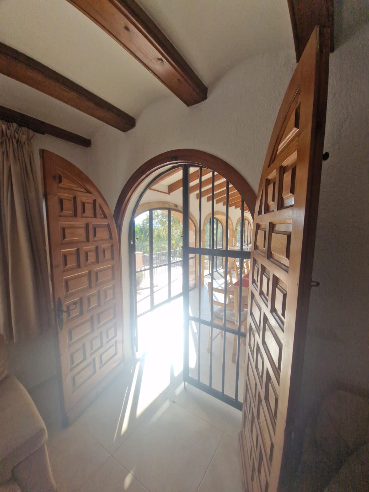 Arched wooden doors to naya terrace