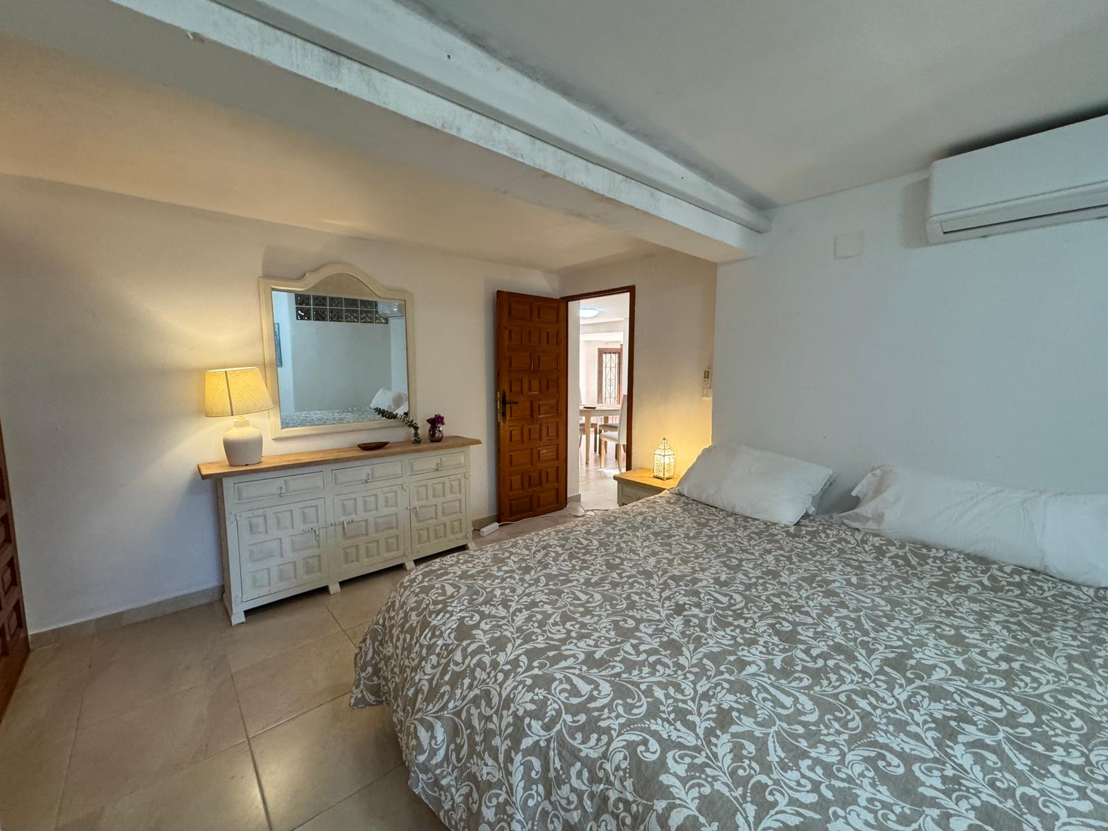 Double bedroom with patterned bedspread at Villa Serena