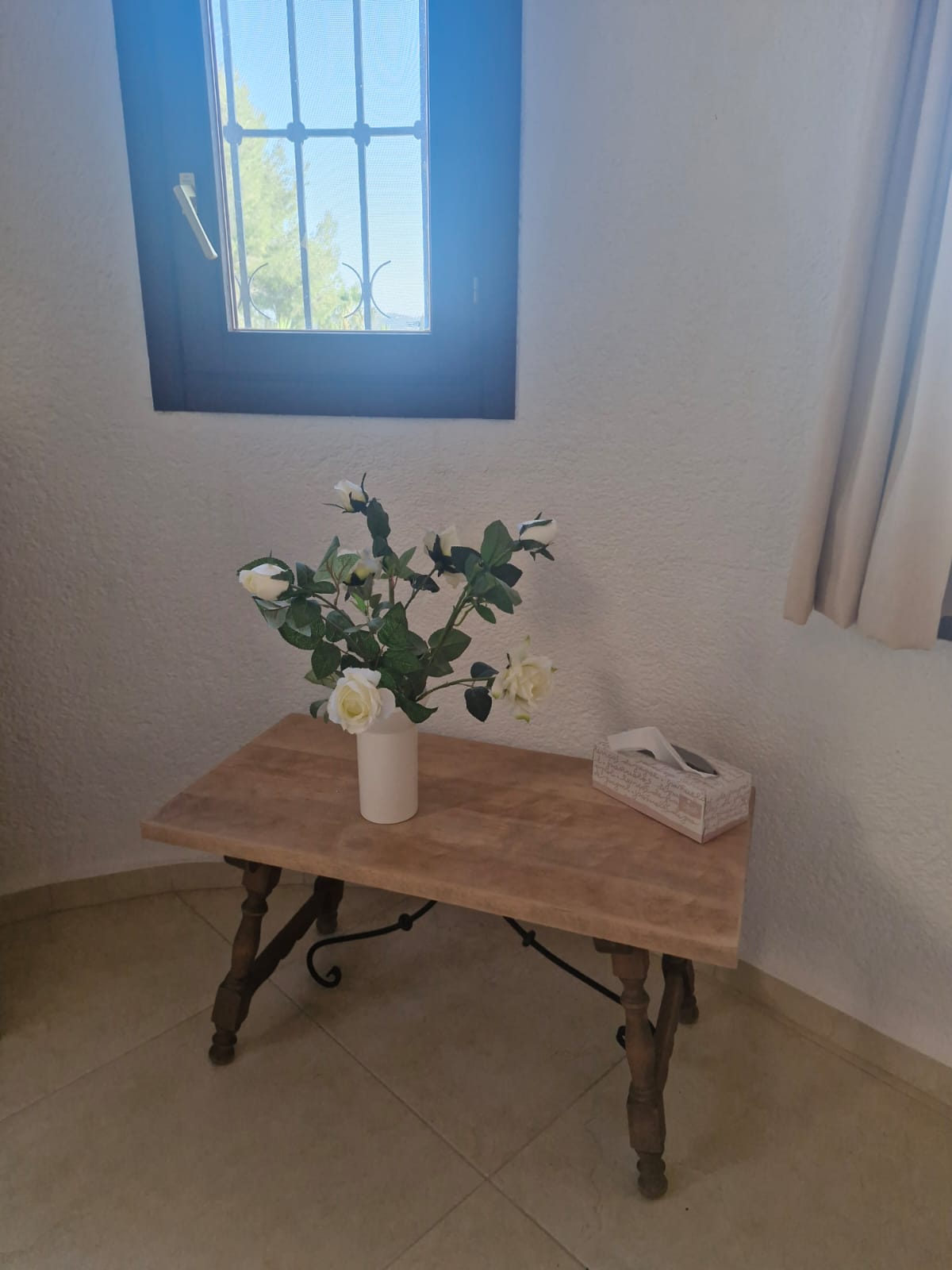 White roses by window