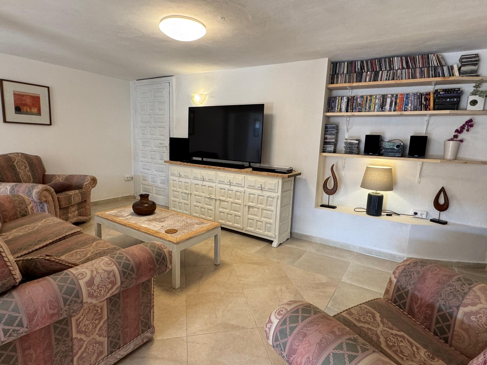 Open-plan living room with wooden ceiling beams