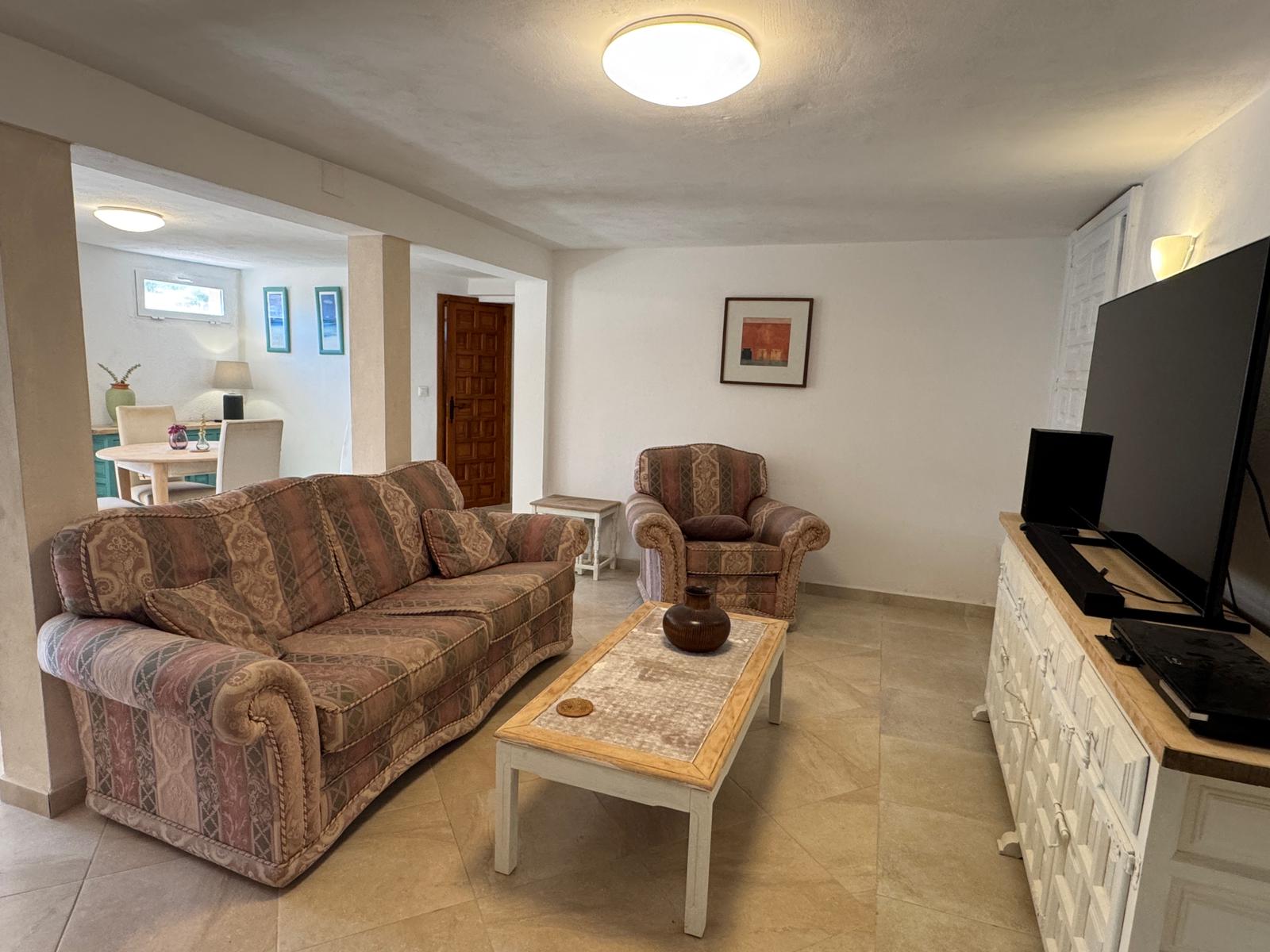 Bright living area with sofas and bookshelves