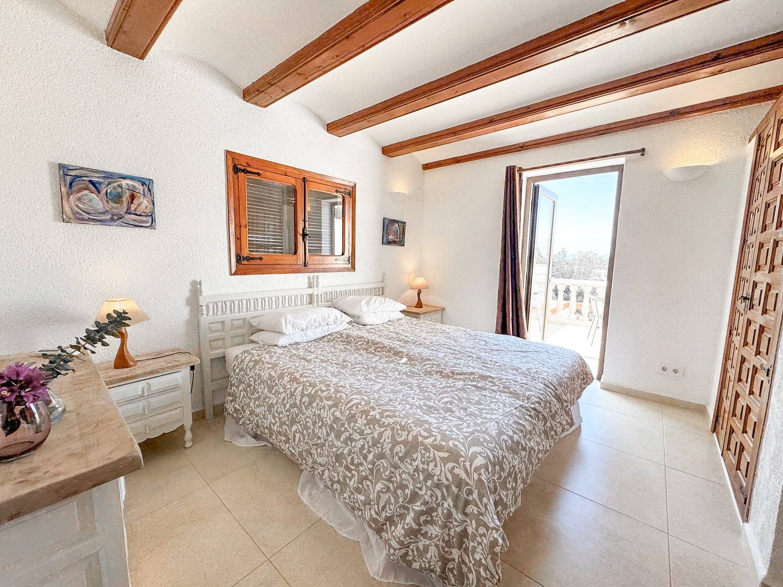Suite 1 — king bed with terrace views